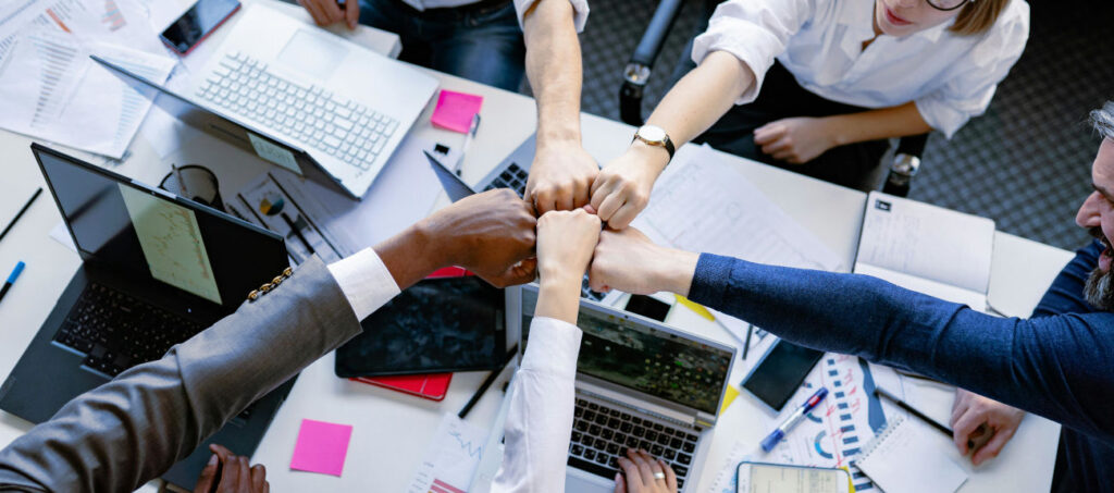 Image of people taking they fist together.